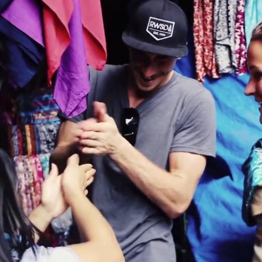 a group of people looking at a cell phone