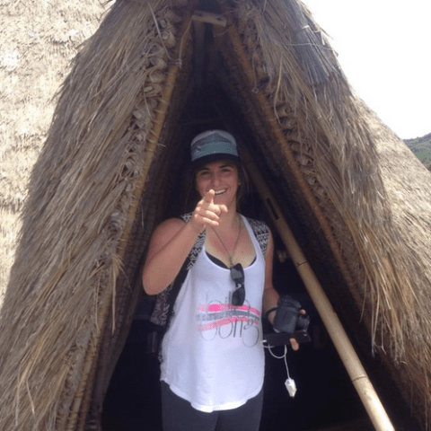 a person wearing a hat and sunglasses posing for the camera
