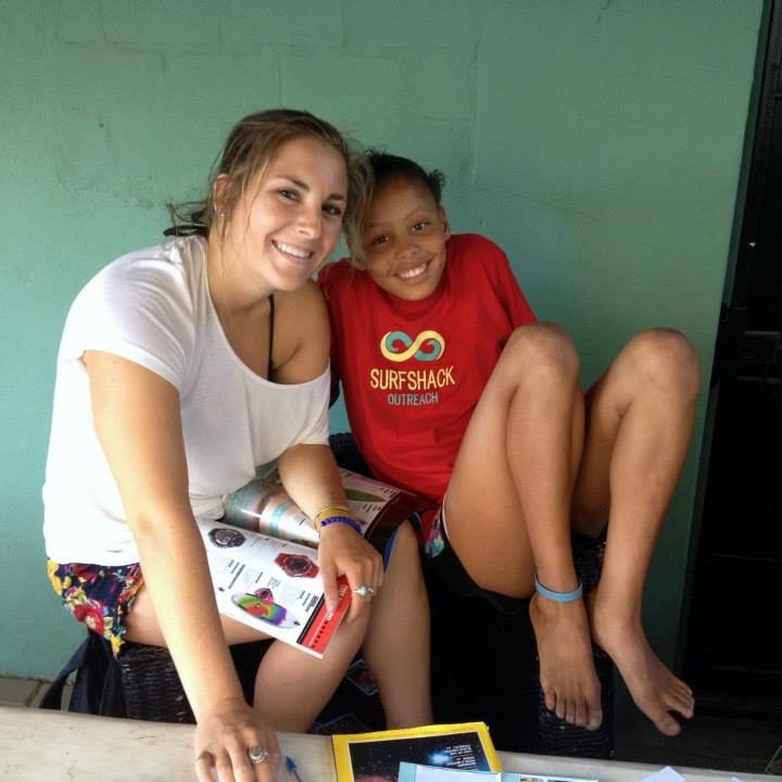 a young boy sitting next to a person