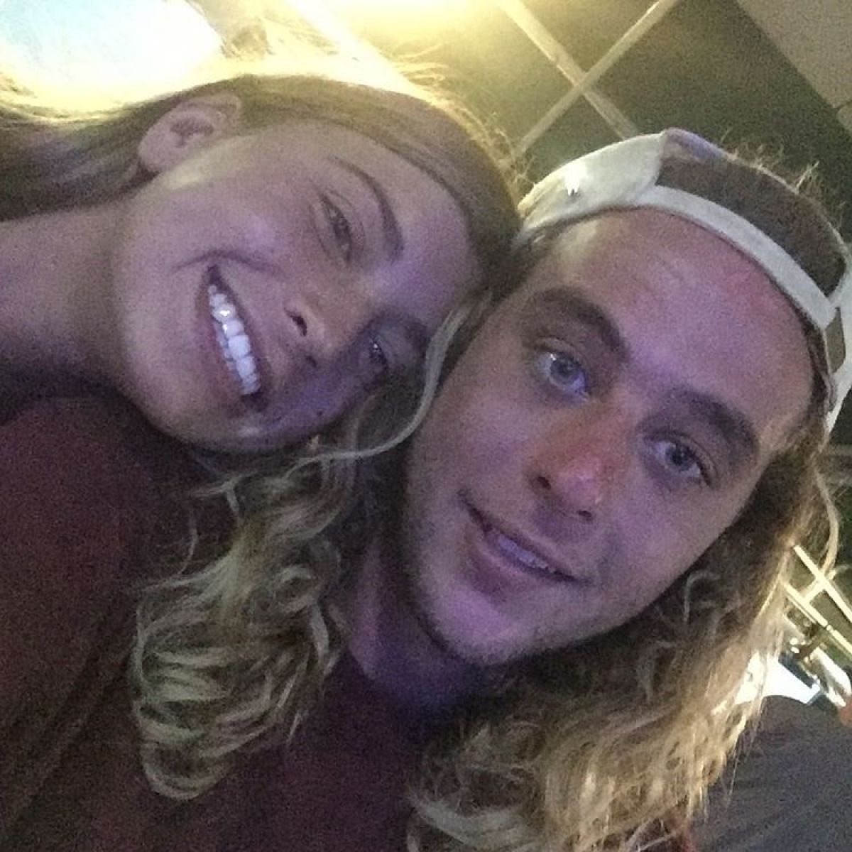 a woman wearing a hat and smiling at the camera