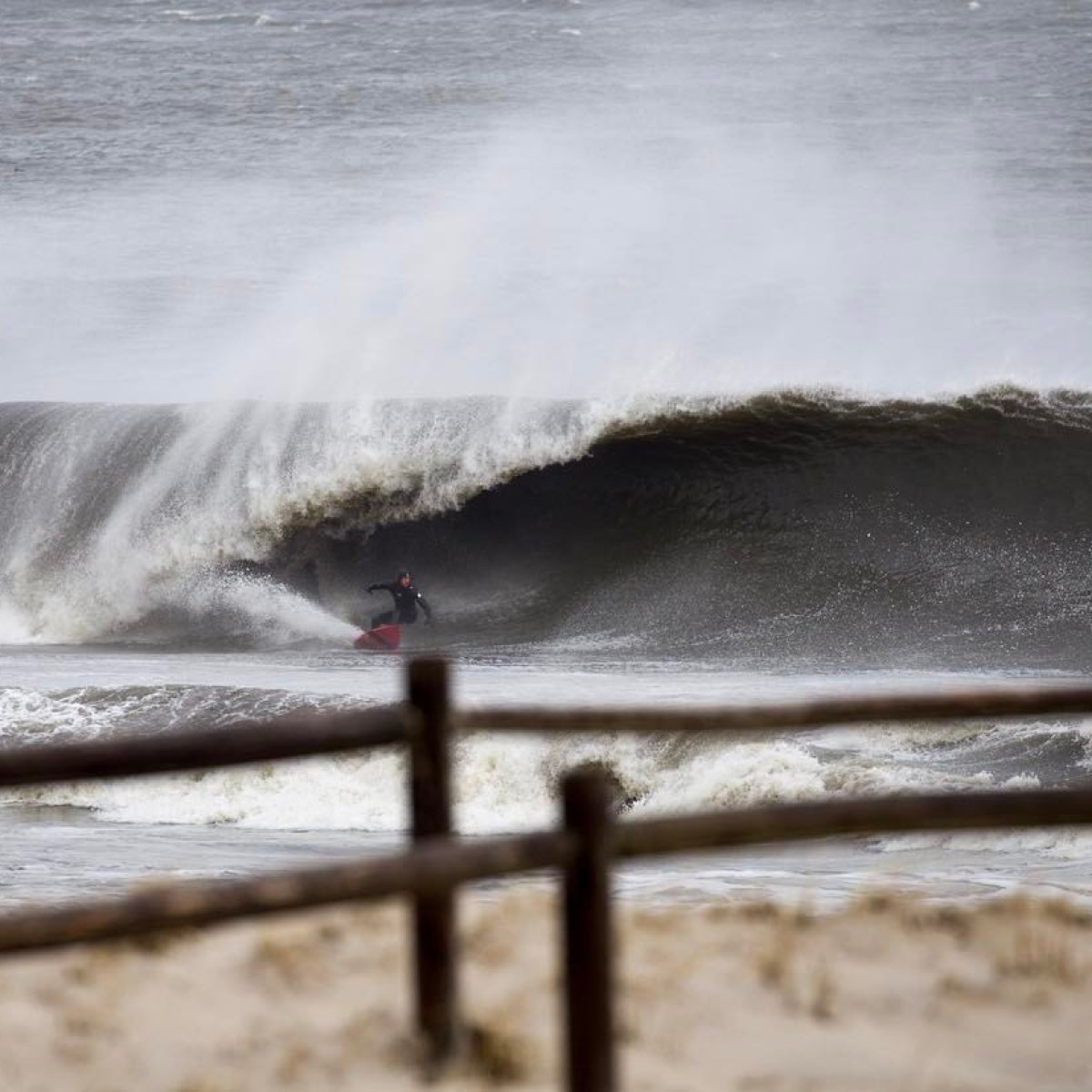 a man riding a wave on top of a body of water