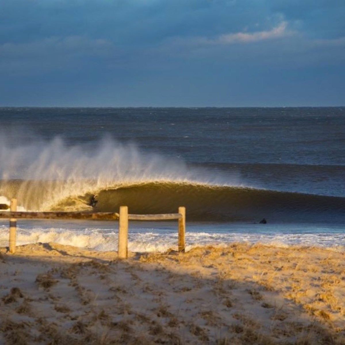 a sandy beach next to a body of water