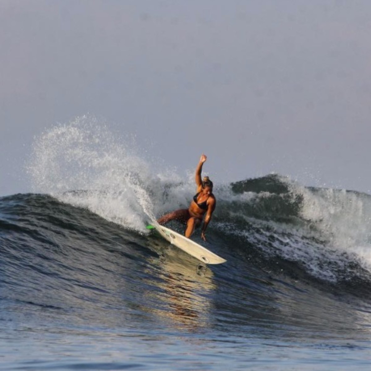 a man riding a wave on a surfboard in the ocean