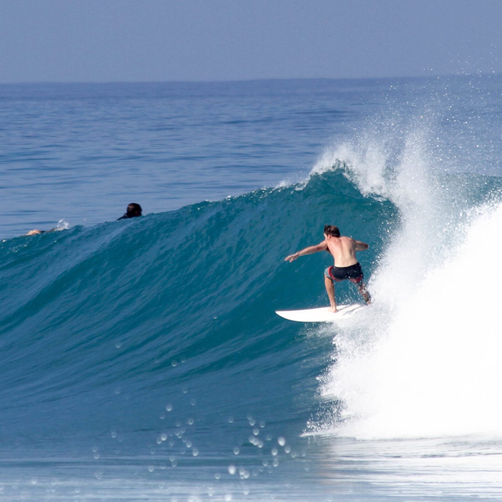 a man riding a wave on a surfboard in the ocean