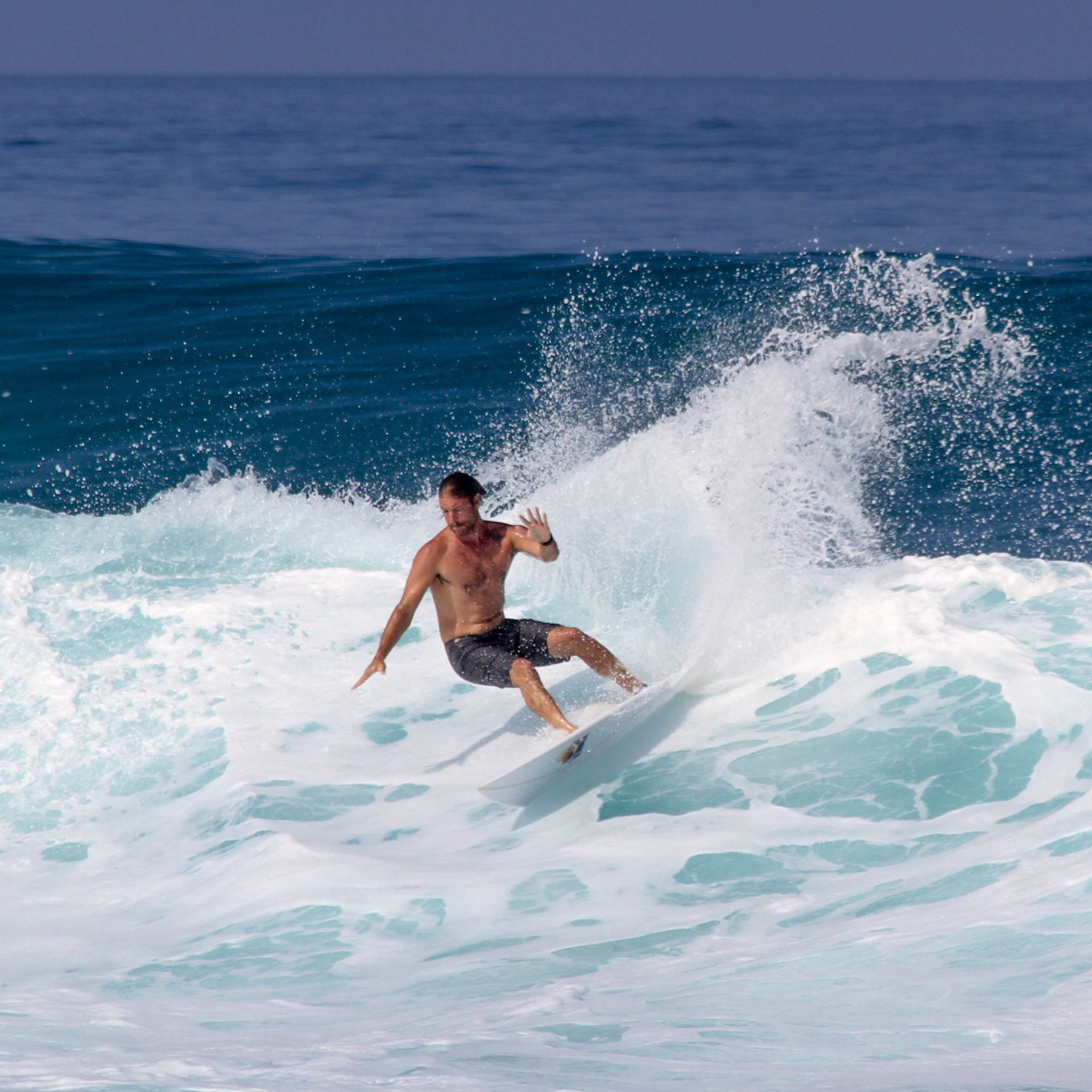 a man riding a wave on a surfboard in the ocean