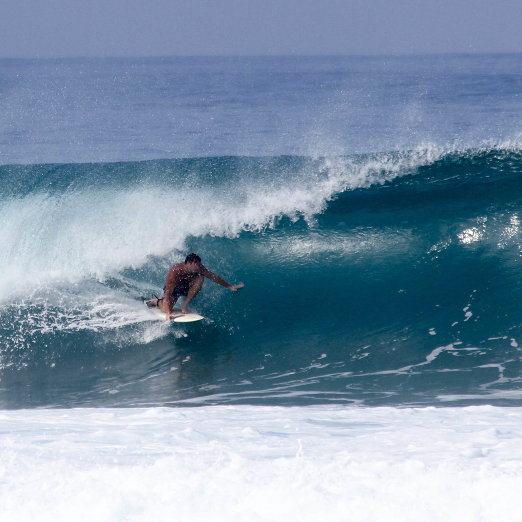 a man riding a wave on a surfboard in the ocean
