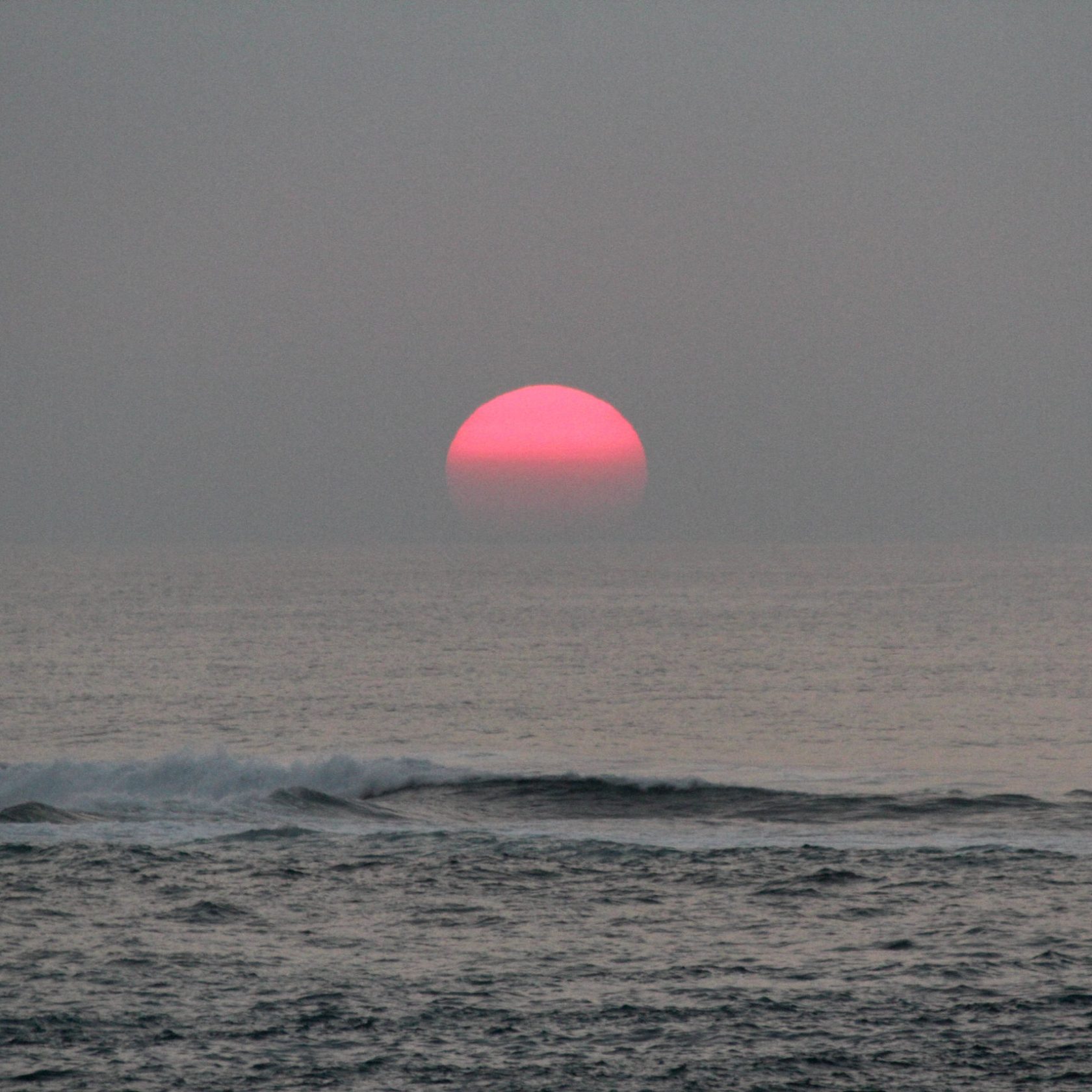 a man flying through the air over a body of water
