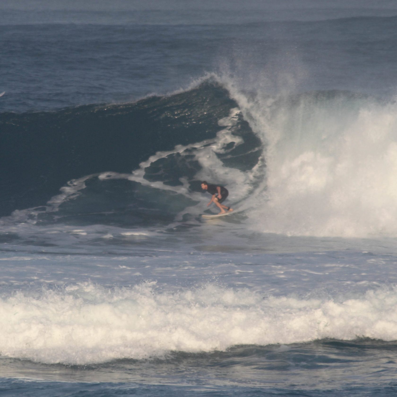 a man riding a wave in the ocean