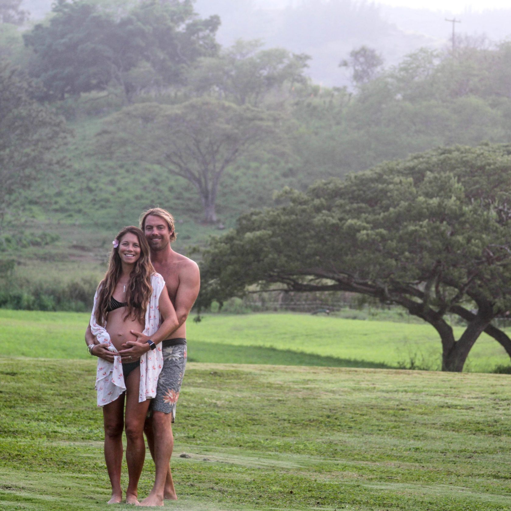 a person standing on top of a grass covered field