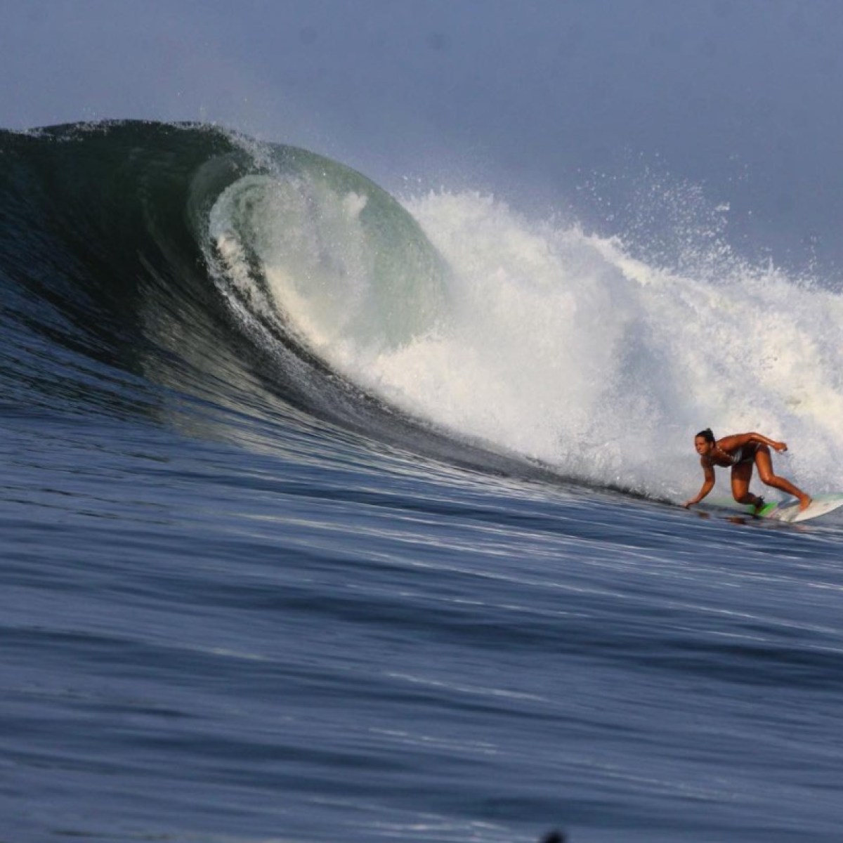 a man riding a wave on a surfboard in the water