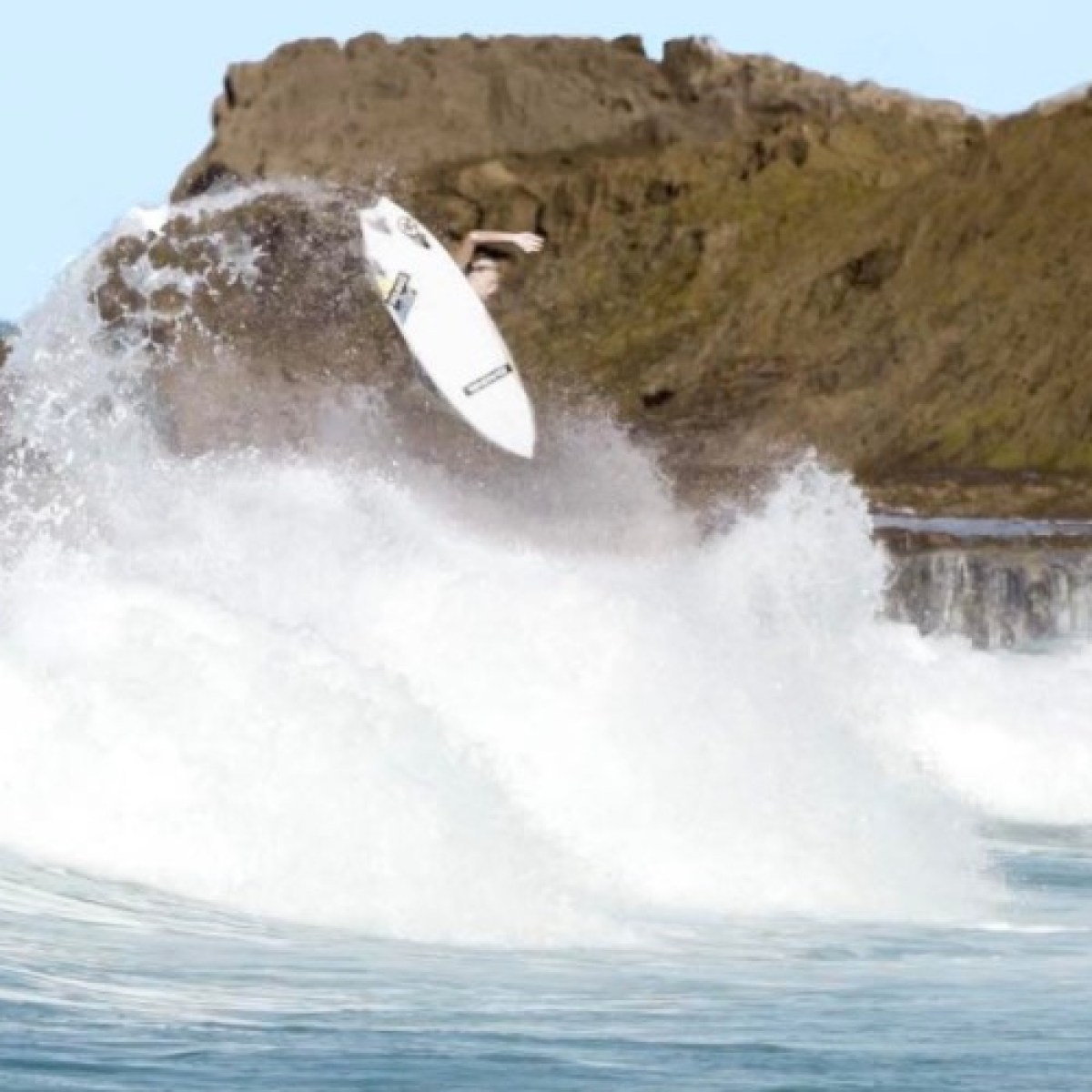 a man riding a wave on a surfboard in the water