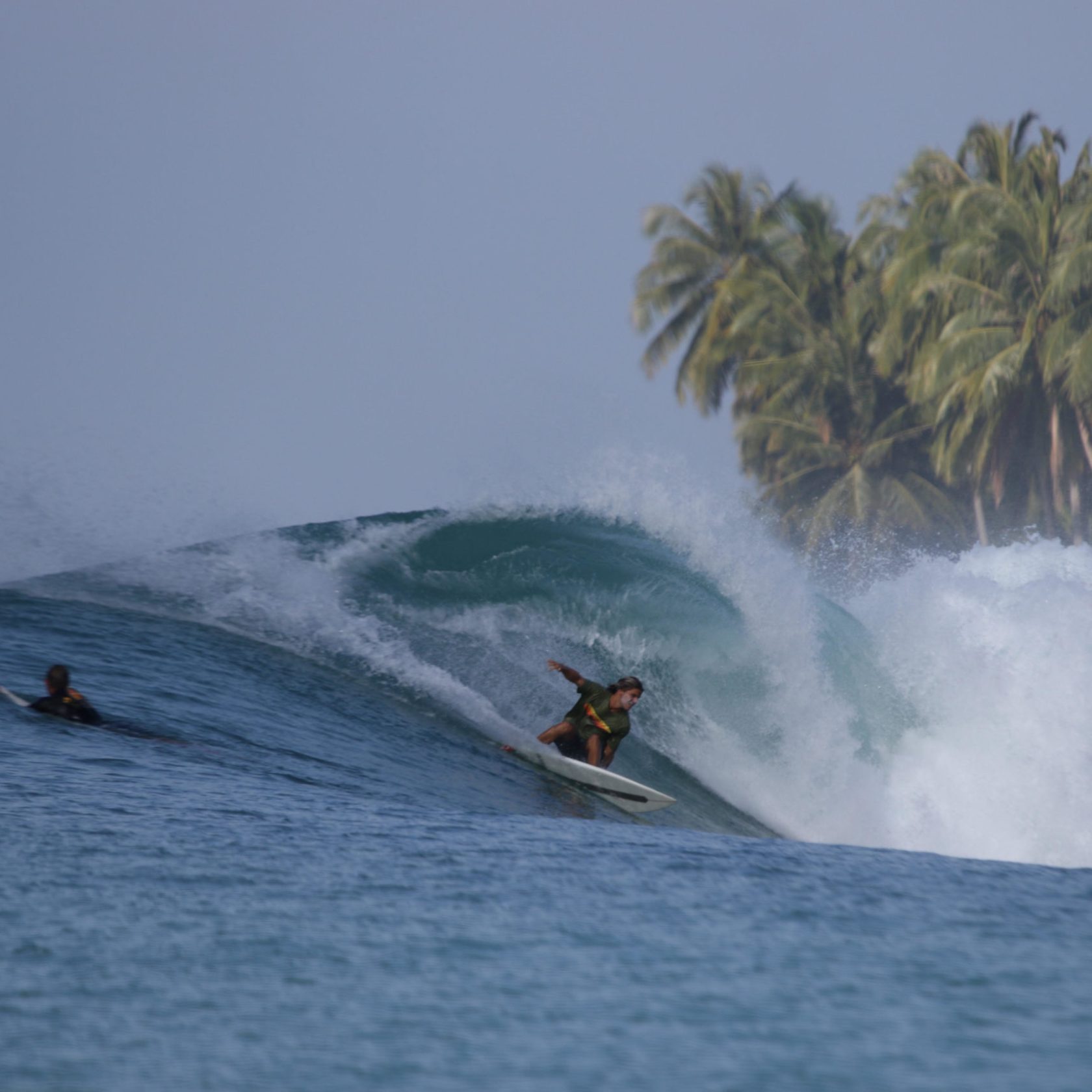 a man riding a wave on a surfboard in the water