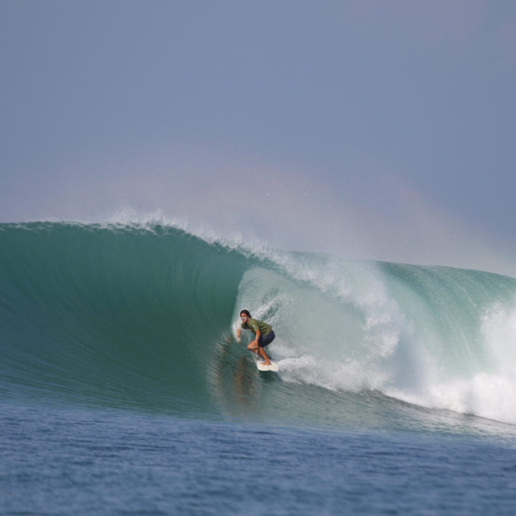 a man riding a wave on a surfboard in the ocean