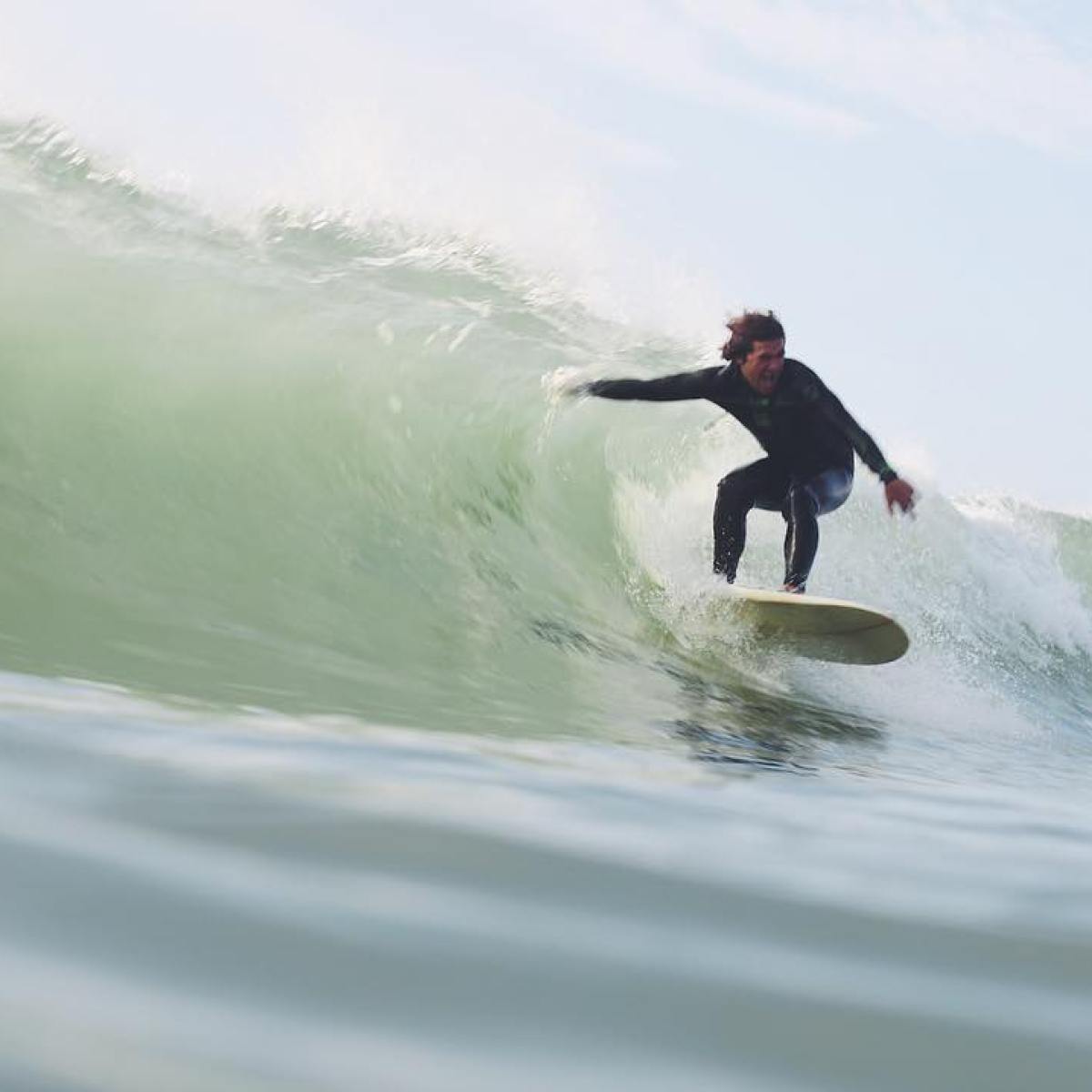 a man riding a wave on a surfboard in the ocean