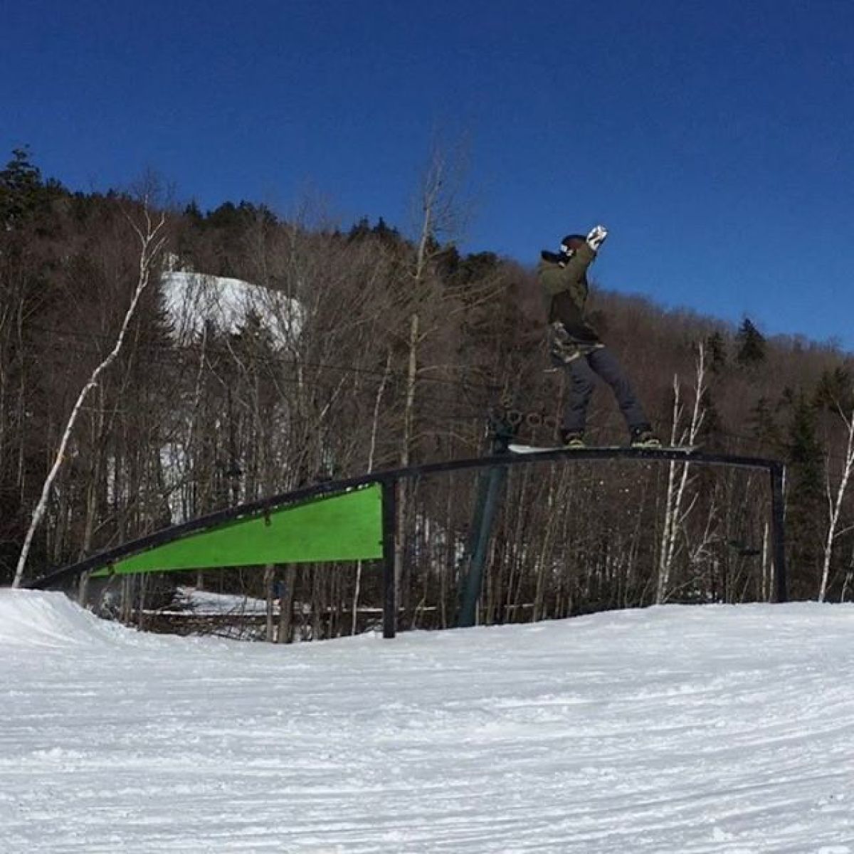 a man riding a snowboard down a snow covered slope