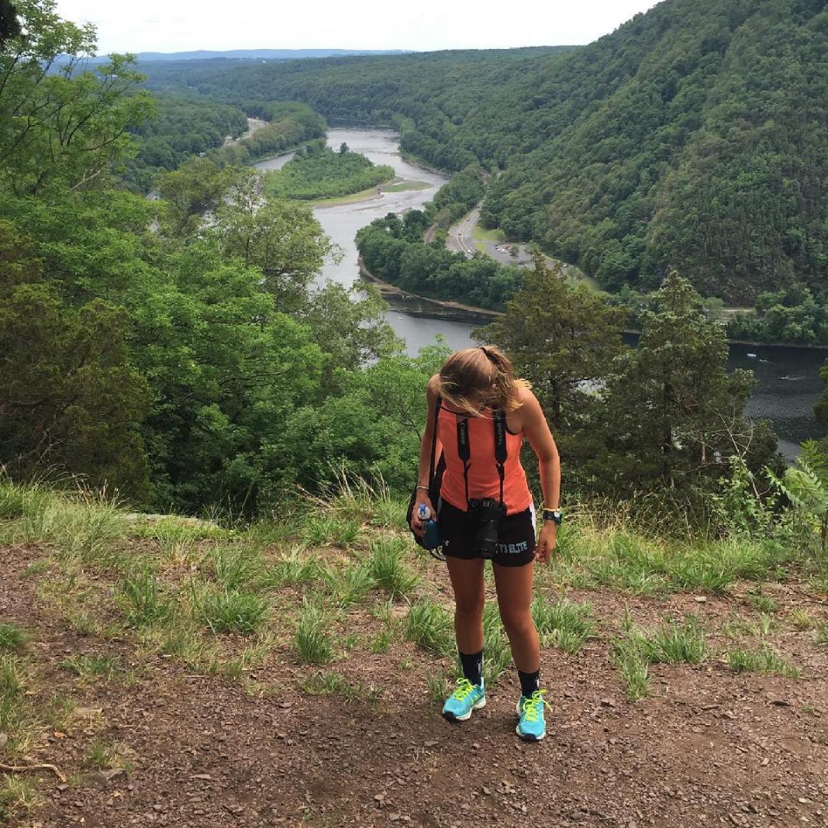 a little boy that is standing on the side of a mountain