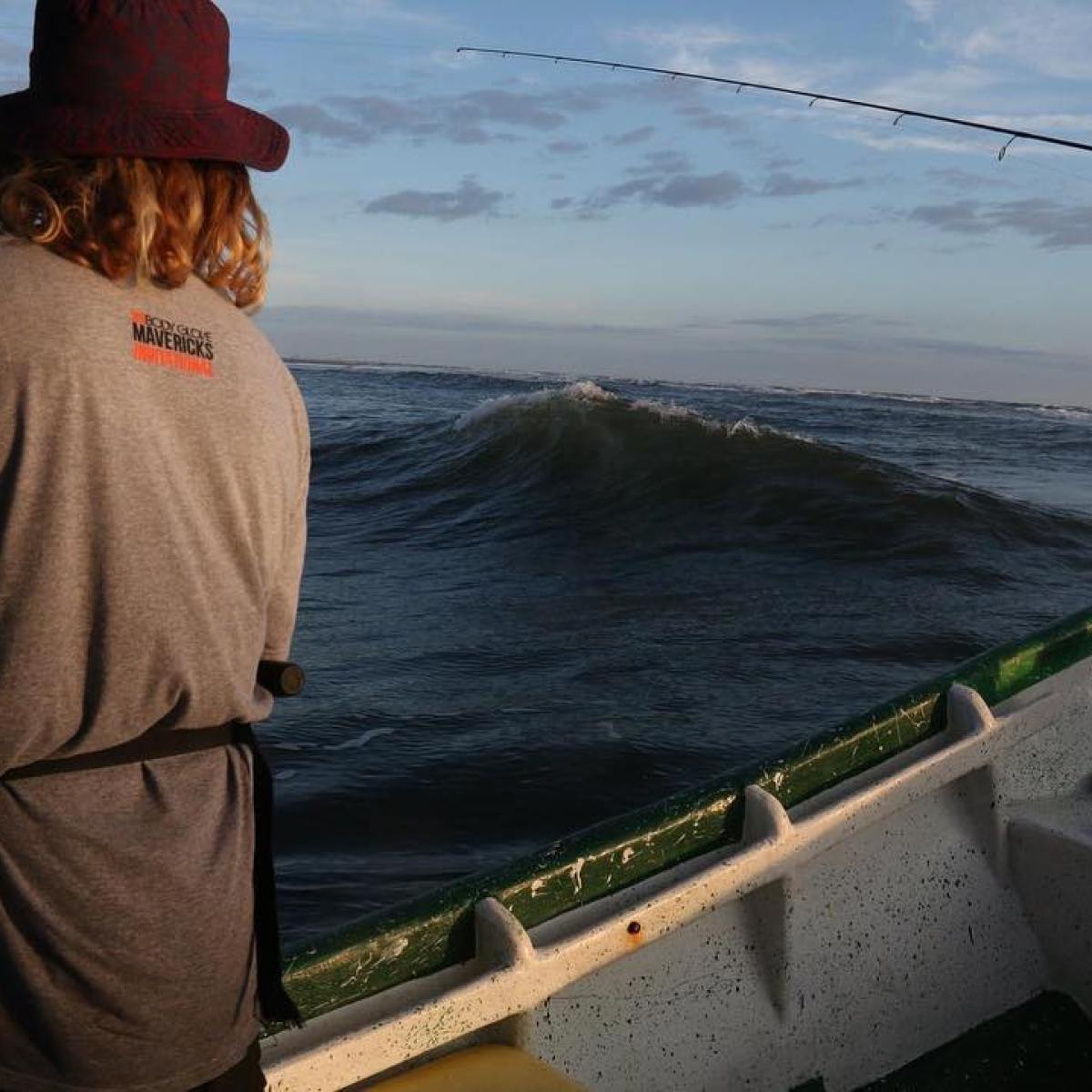 a person standing next to a body of water
