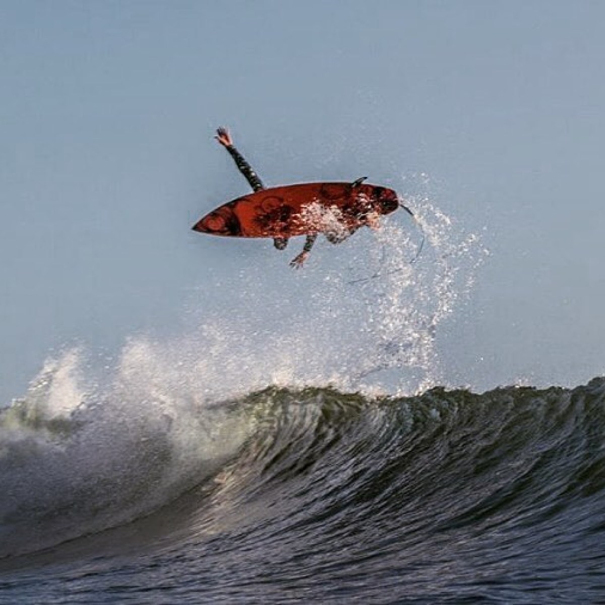 a man riding a wave on a surfboard in the water