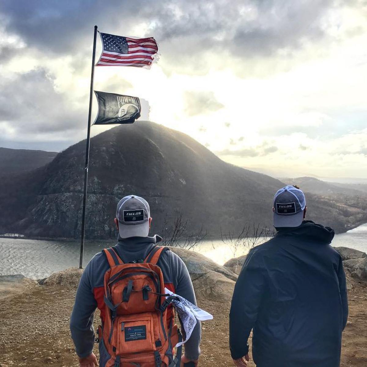 a couple of people standing on top of a mountain