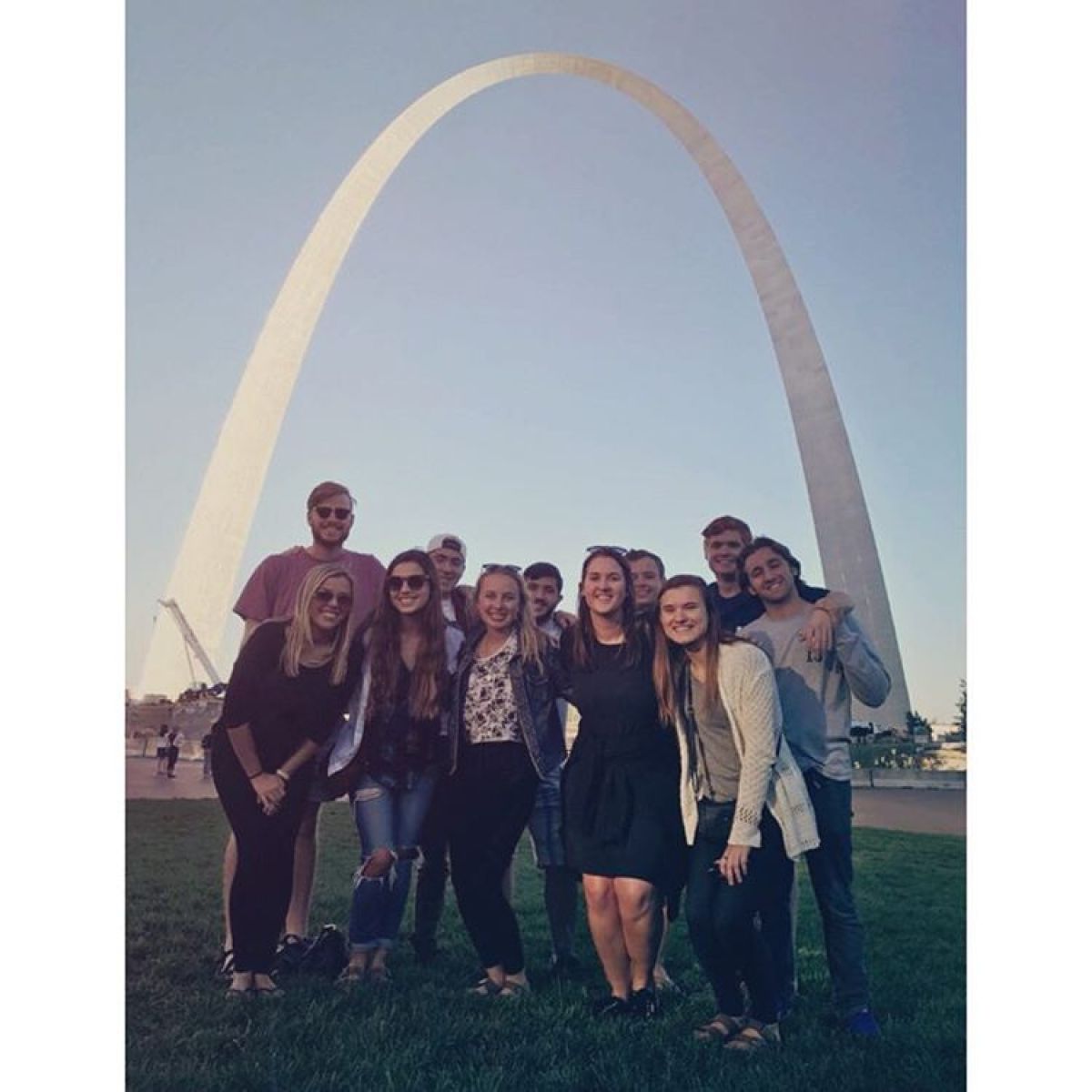 a group of people standing in front of a crowd posing for the camera