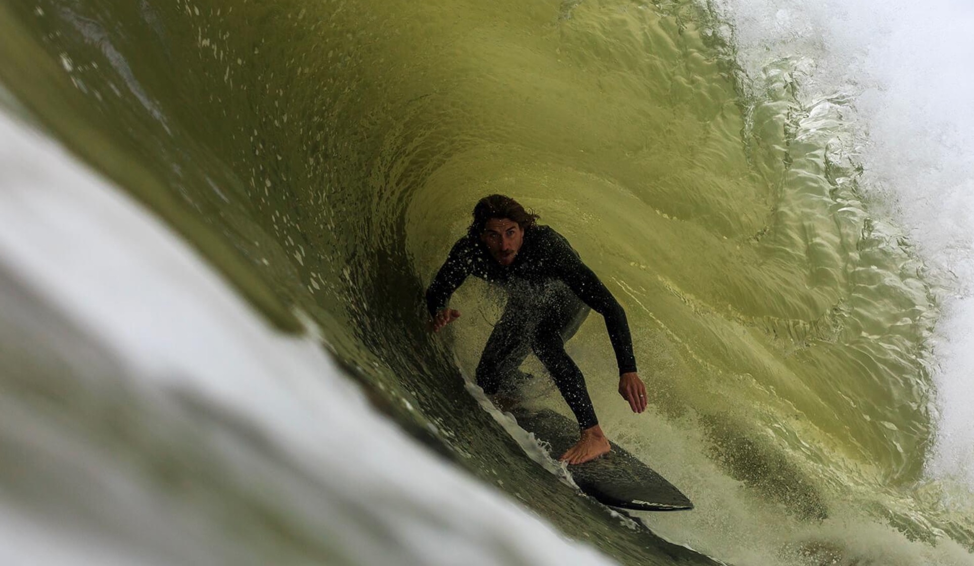 a man riding a wave on a surfboard in the ocean