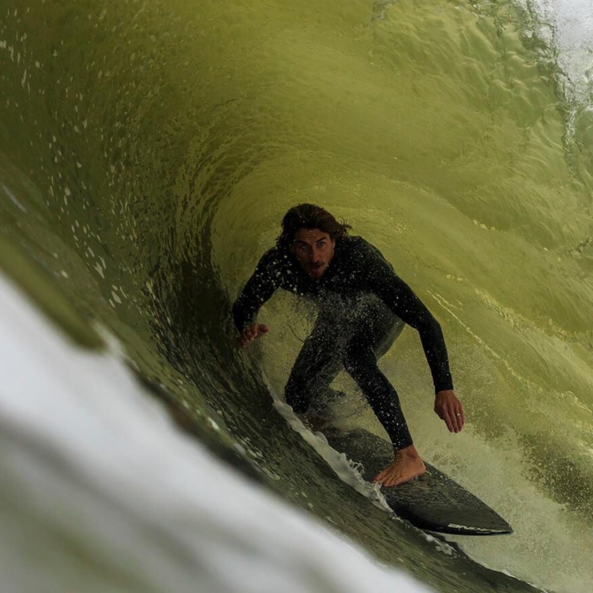 a man riding a wave on a surfboard in the ocean