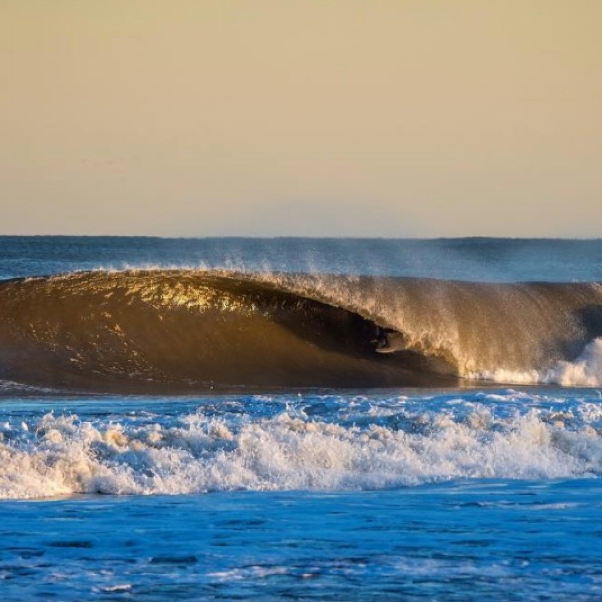 a person riding a wave on a surfboard in the ocean