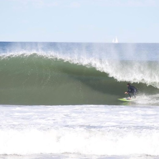 a man riding a wave on a surfboard in the water