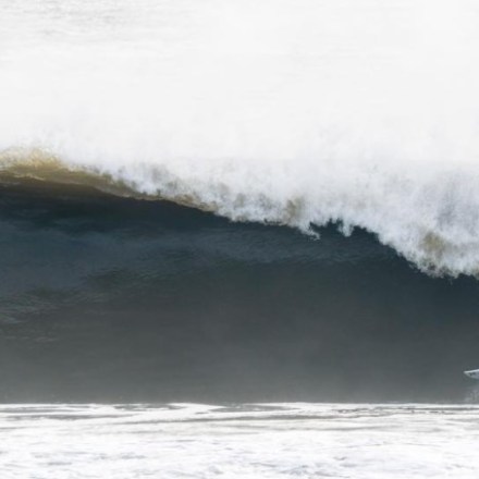 a man riding a wave on a surfboard in the ocean
