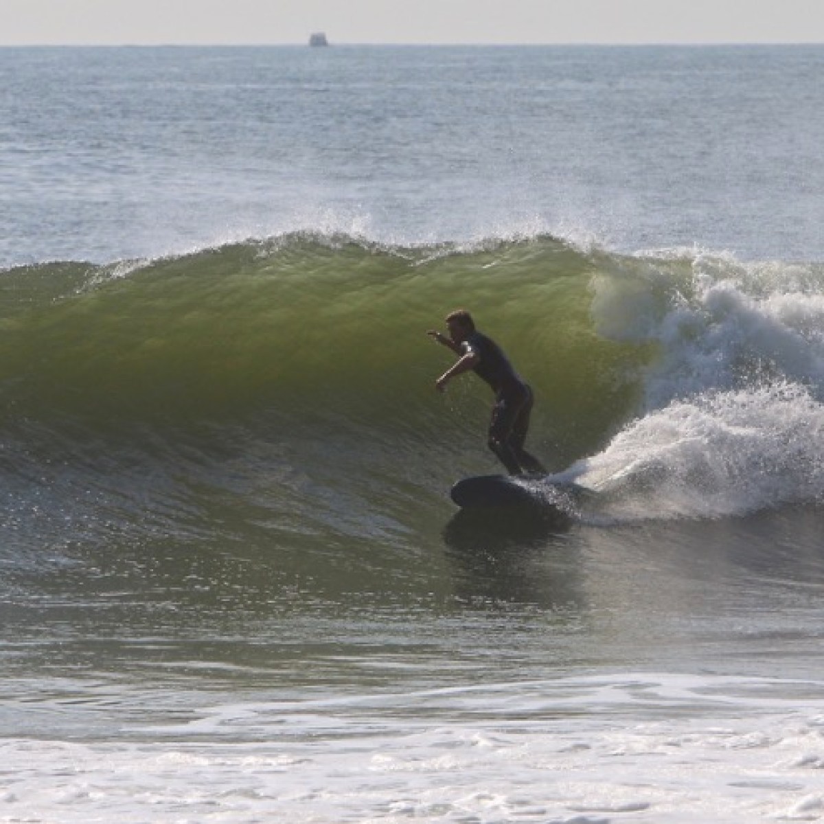 a man riding a wave on a surfboard in the ocean