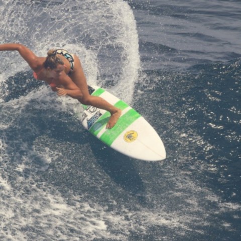 a young man riding a wave on a surfboard in the ocean