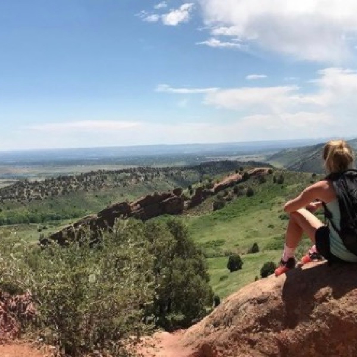 a man standing on a rocky hill