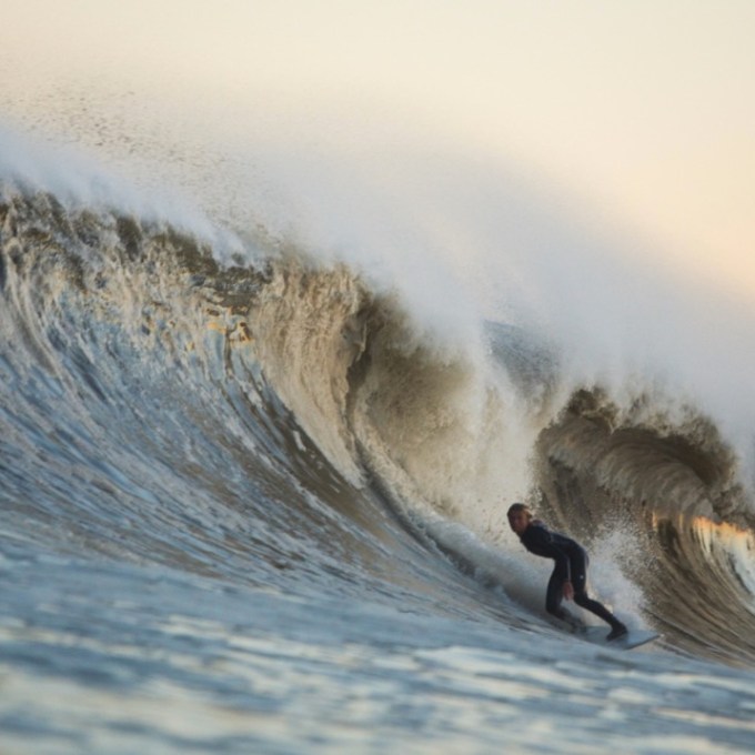a man riding a wave on a surfboard in the ocean