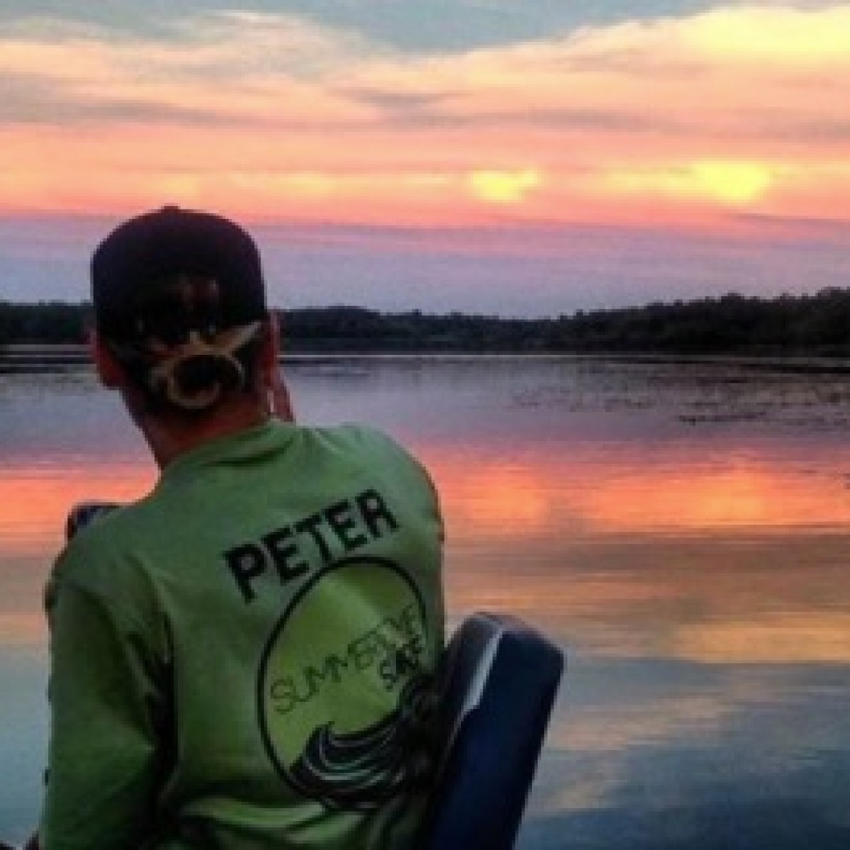 a man standing in front of a body of water