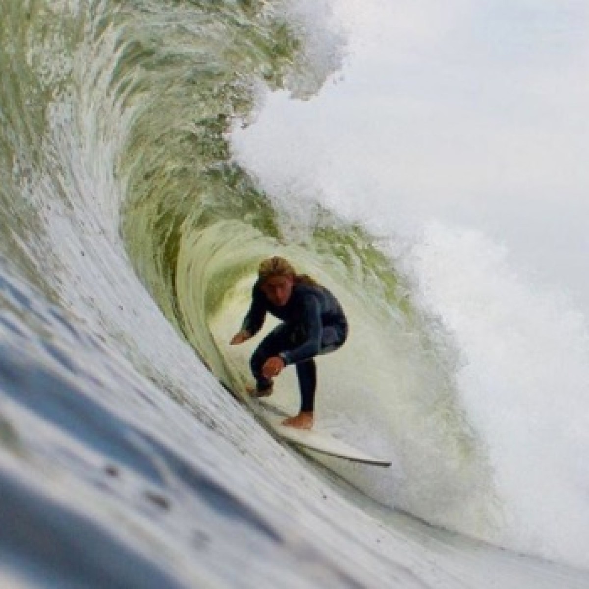 a man riding a wave on a surfboard in the water