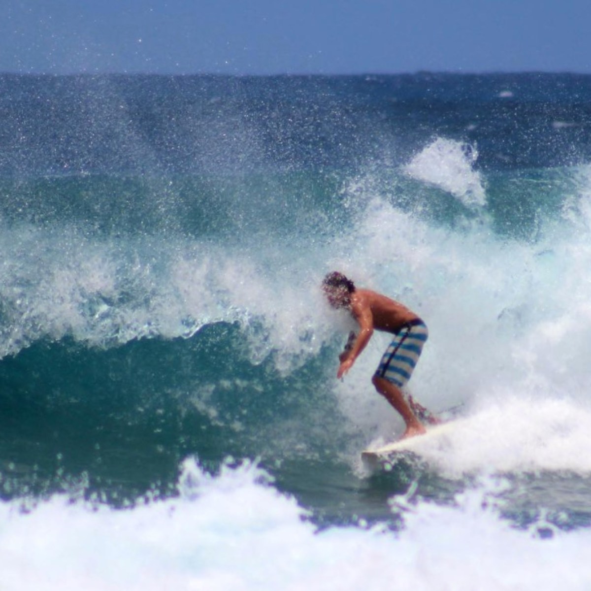 a man riding a wave on a surfboard in the ocean