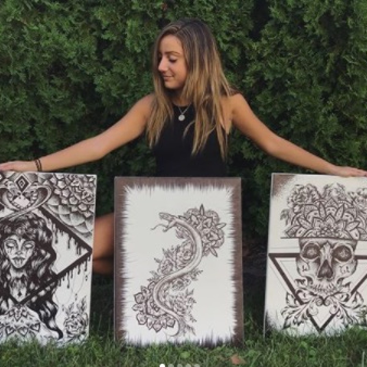 a woman holding a sign posing for the camera
