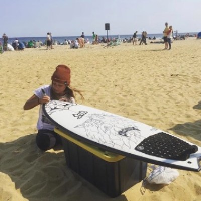 a man sitting on top of a sandy beach