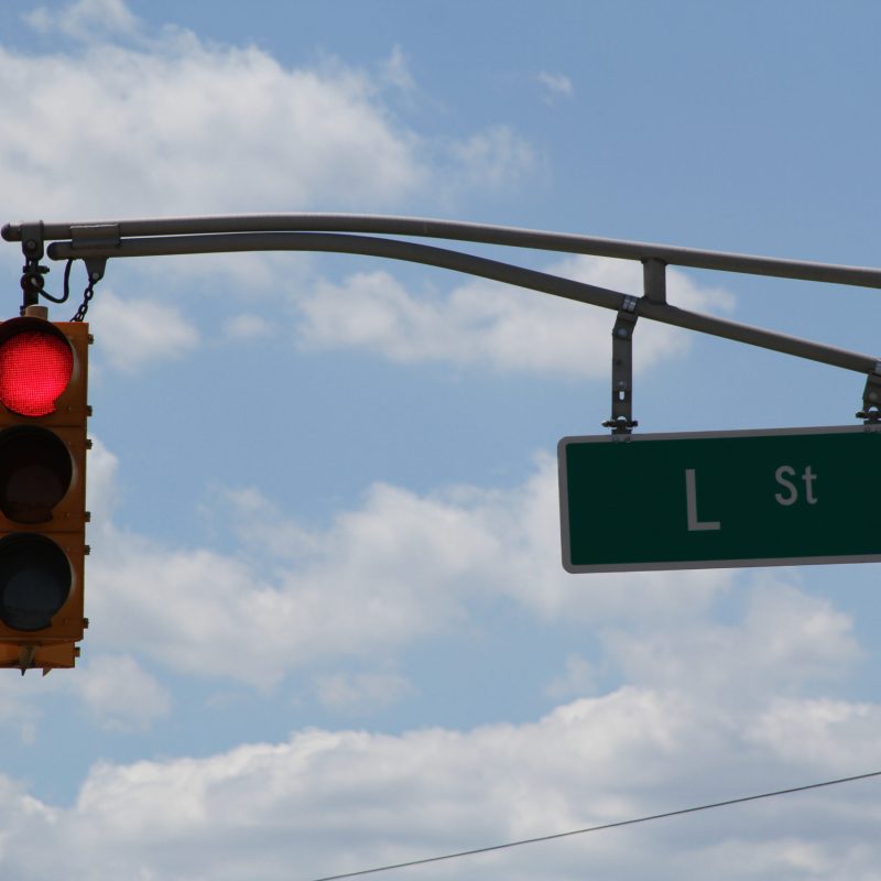 a street sign next to a traffic light