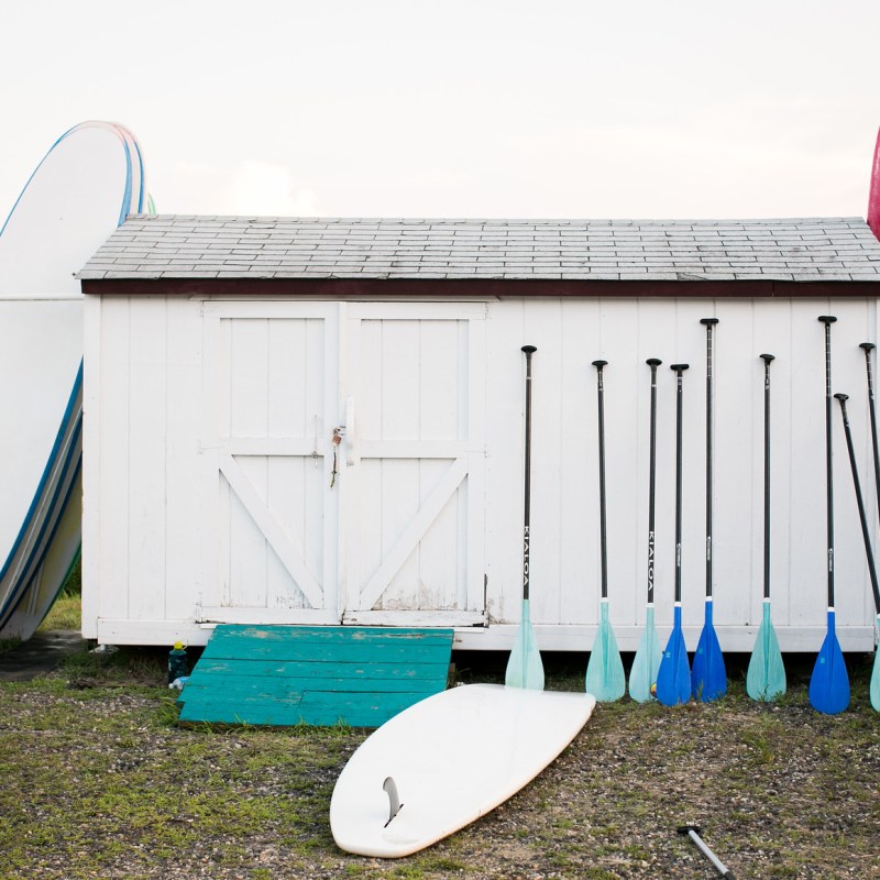 a boat sitting on top of a grass covered field