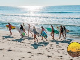a group of people walking on a beach