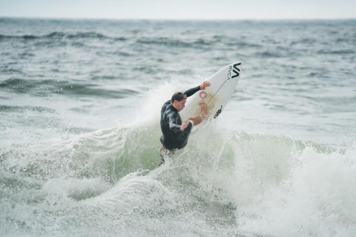 a man riding a wave on a surfboard in the ocean