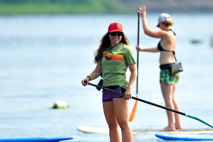 a woman rowing a boat in the water