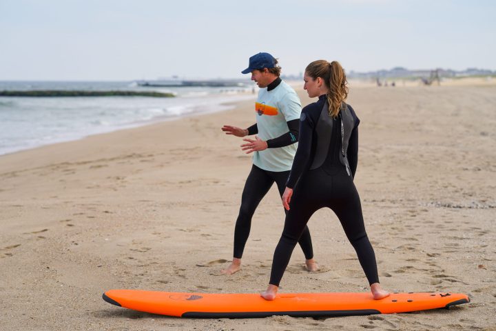 a person standing next to a body of water