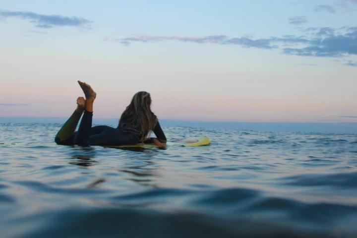 a man riding a wave on a surfboard in the water