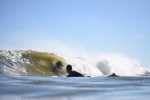 a man riding a wave on a surfboard in the water