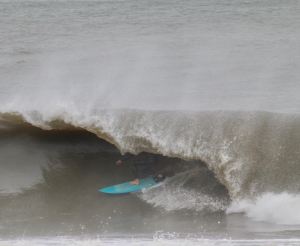 a man riding a wave on a surfboard in the water