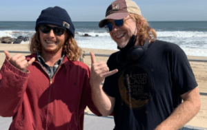 a man and a woman standing next to a body of water