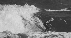 a man riding a wave on a surfboard in the ocean