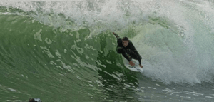 a man riding a wave on a surfboard in the ocean